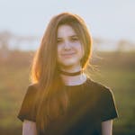 Woman Wearing Black Crew-neck T-shirt and Black Choker Necklace